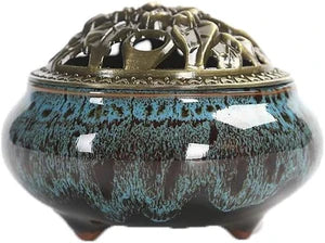 Ceramic incense burner with decorative top on a white background